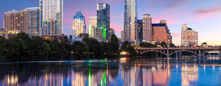 A riverside view of Lady Bird Lake with downtown Austin in the background.