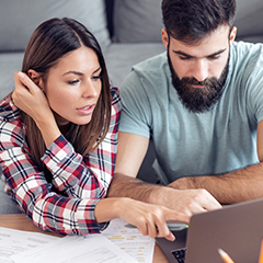 Two people looking at a laptop