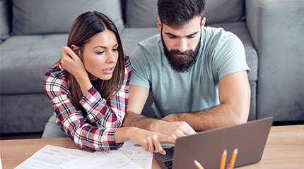 Two people looking at a laptop