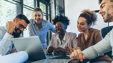 A group of diverse employees collaborate on a project.