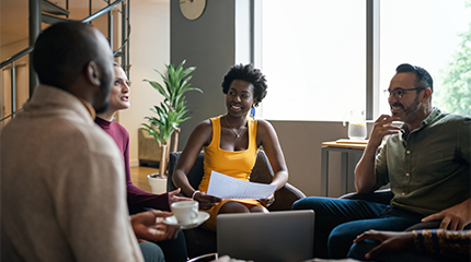 Four people in a room discussing something