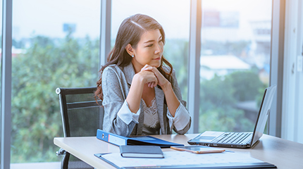 business person looking at laptop smiling