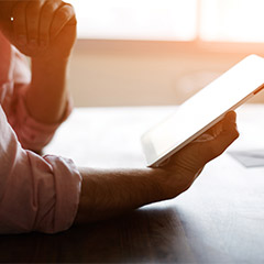 A person reading from a tablet