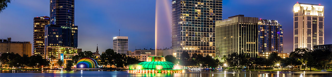 A nighttime landscape of the pond at Lake Eola Park in downtown Orlando.