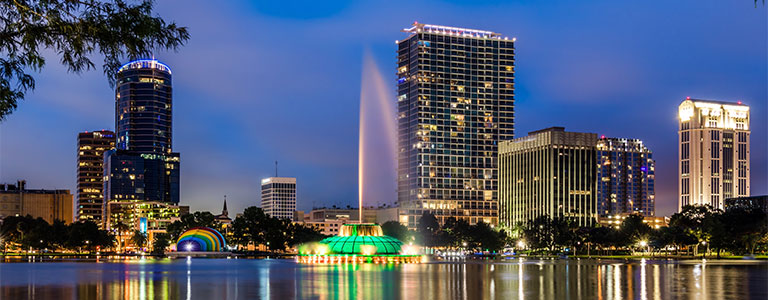 A nighttime landscape of the pond at Lake Eola Park in downtown Orlando.
