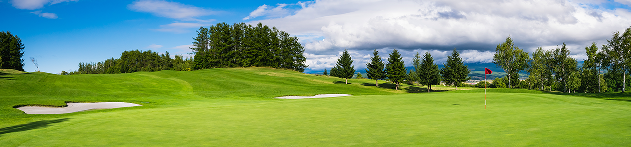 A green, hilly golf course.