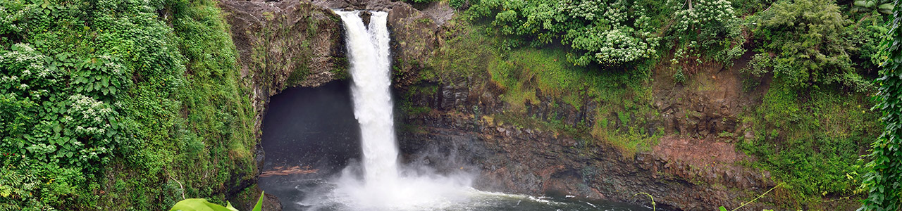 A waterfall surrounded by mossy rocks.