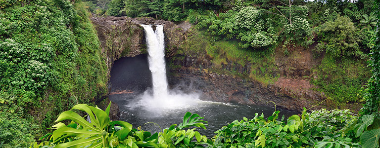 A waterfall surrounded by mossy rocks.