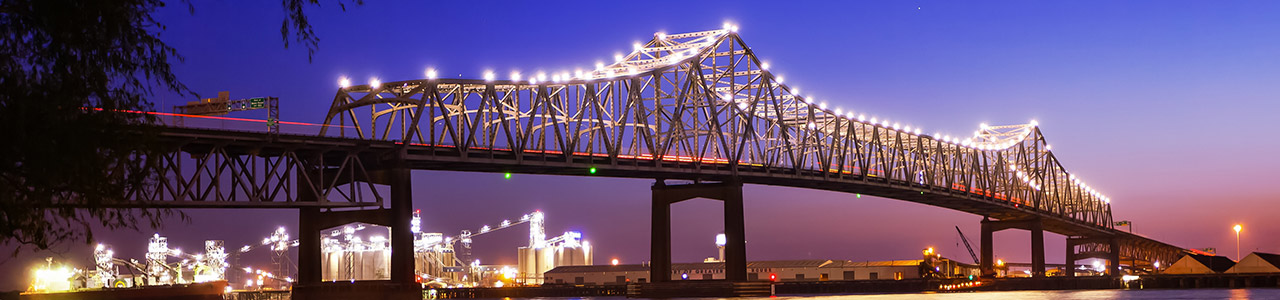 A bridge stands over a dark waterway.