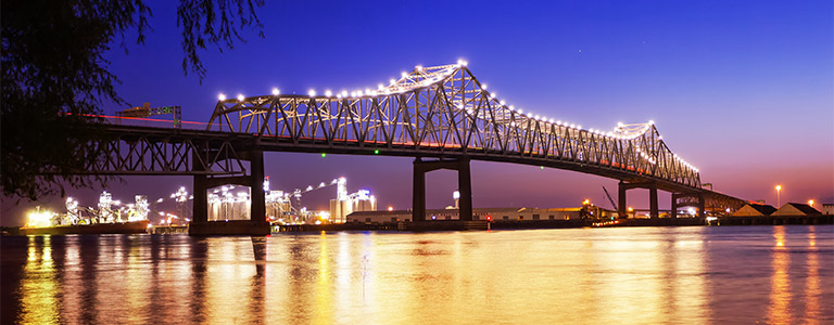 A bridge stands over a dark waterway.