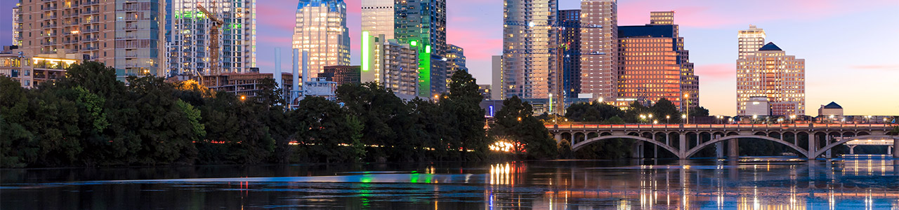 A riverside view of Lady Bird Lake with downtown Austin in the background.