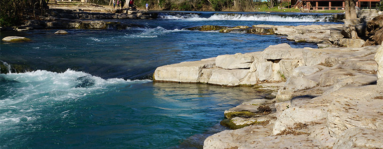 A river flows along a rocky shore.